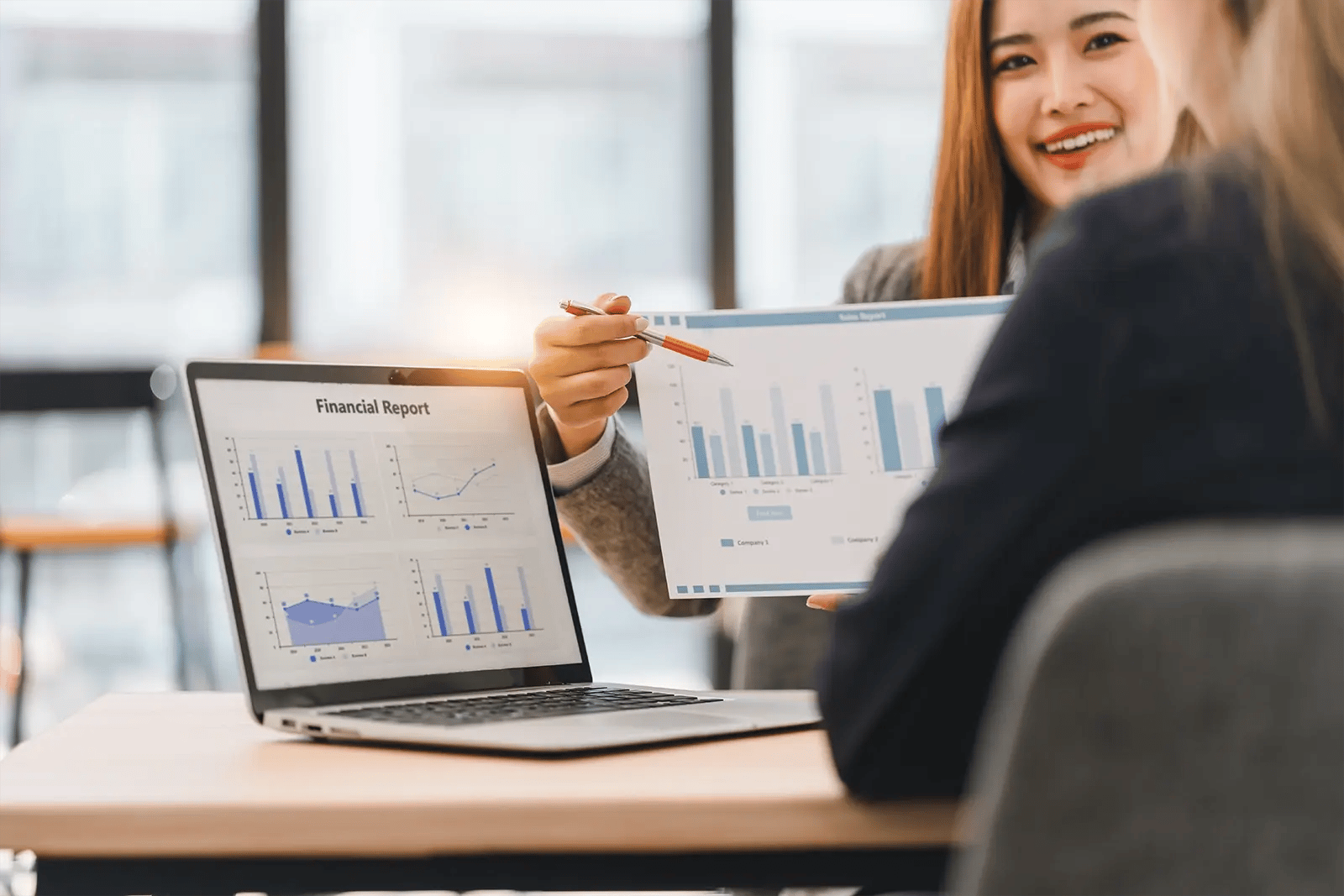 two_business_professionals_discussing_financial_re-4c3d3ba2b7889b3ee5a1